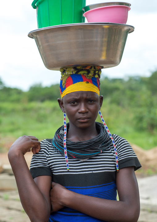 Benin, West Africa, Taneka-Koko, a fulani peul tribe woman carrrying buckets on her head