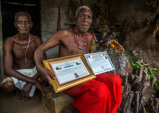 Benin, West Africa, Bopa, dah tofa voodoo master showing his diplomas in his temple