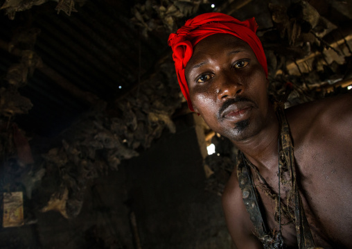 Benin, West Africa, Bopa, scary voodoo adept with a red scarf during a ceremony