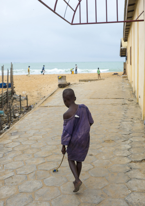 Benin, West Africa, Cotonou, boy playing on the beach