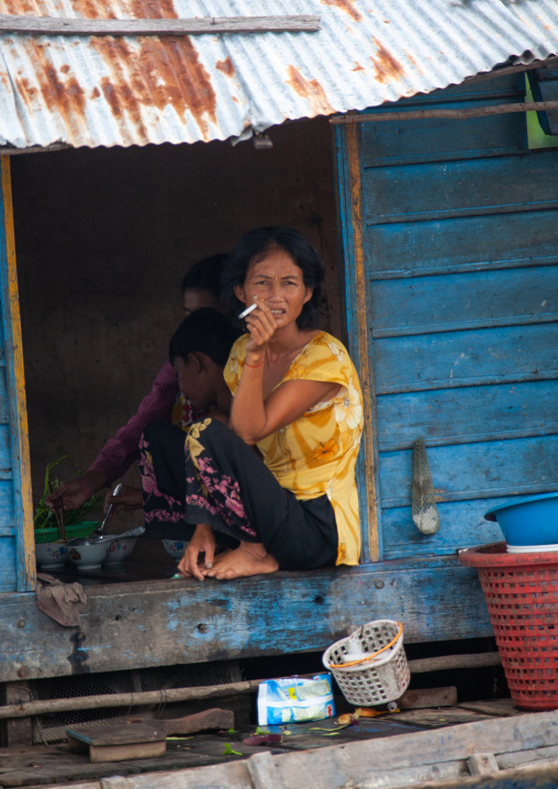 Cambodian woman standing at the door of her house in the floating village on Tonle Sap lake, Siem Reap Province, Chong Kneas, Cambodia