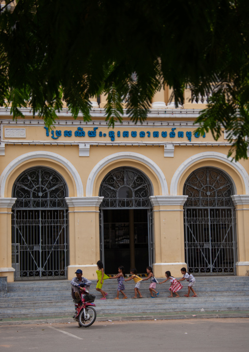 Cambodian children playing in front of the french-era post office, Phnom Penh province, Phnom Penh, Cambodia