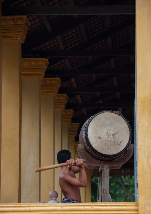 Buddhist monk beats drum in Angkor wat, Siem Reap Province, Angkor, Cambodia