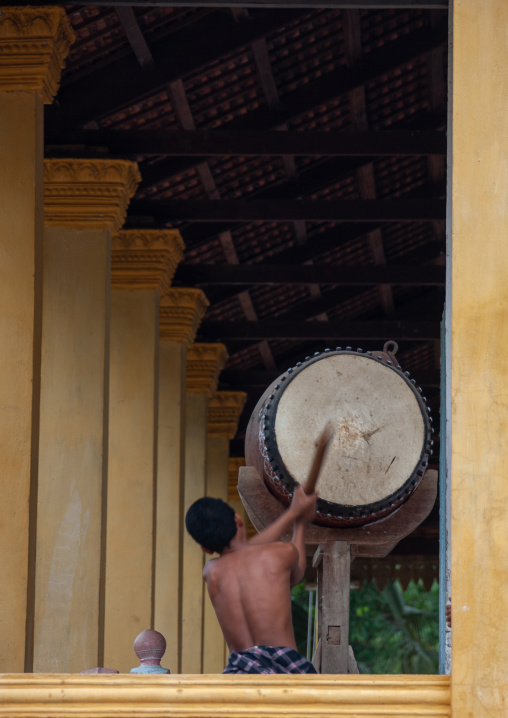 Buddhist monk beats drum in Angkor wat, Siem Reap Province, Angkor, Cambodia