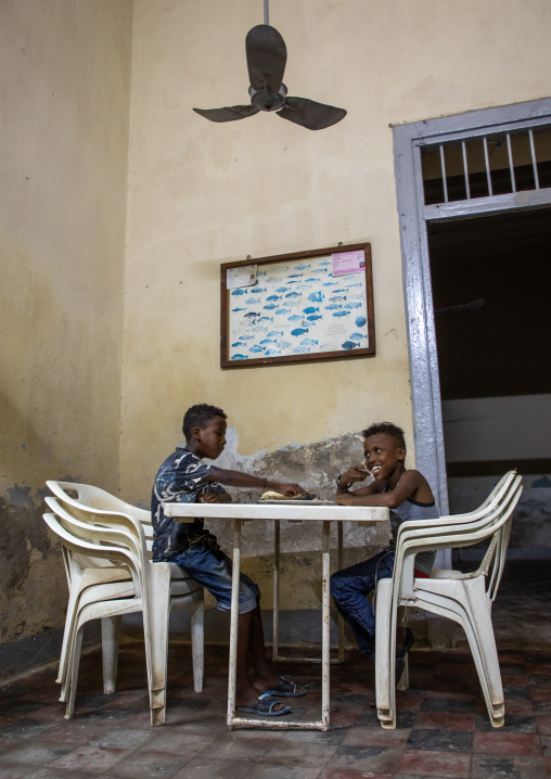 Children eating fish in selam restaurant, Northern Red Sea, Massawa, Eritrea