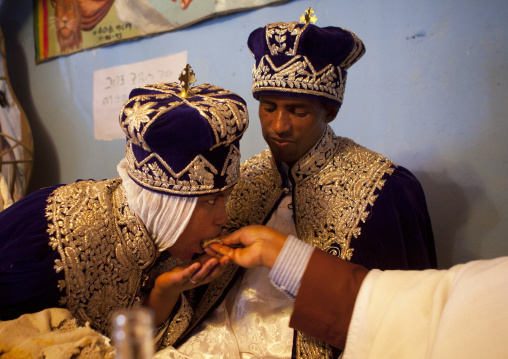 Priest feeding newlyweds during an Ethiopian wedding in an orthodox church, Zway, Ethiopia