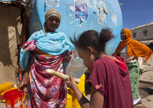 Women Fulling Up Cans From A Water Tanker, Harar, Ethiopia