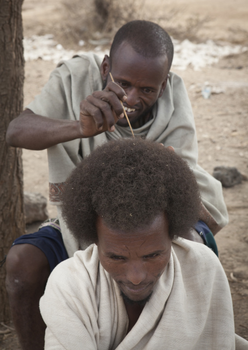 Karrayyu Tribe Man Having His Gunfura Traditional Hairstyle Done In Gadaaa Ceremony, Metehara, Ethiopia