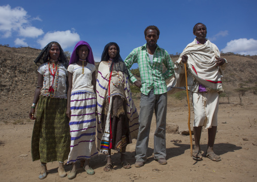 Roba Bulga And His Karrayyu Family Dressed In Traditionnal And Modern Clothes Down A Rocky Hill, Metahara, Ethiopia