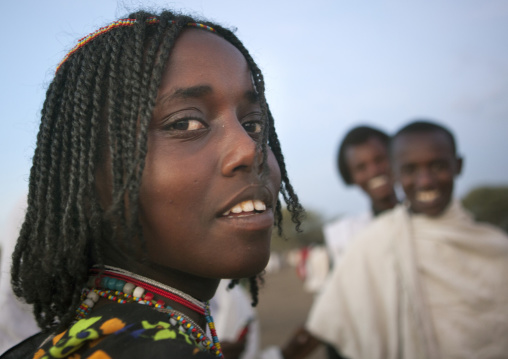 Karrayyu Tribe Girl With Stranded Hair Near Two Smiling Karrayyu Tribe Boys At Gadaaa Ceremony, Metehara, Ethiopia