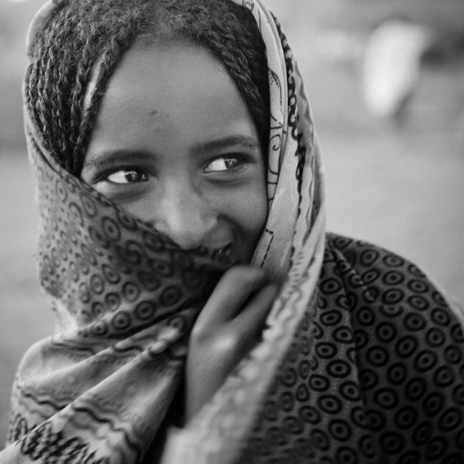 Smiling Karrayyu Tribe Girl With Stranded Hair Hiding Behind Her Headscarf At Gadaaa Ceremony, Metehara, Ethiopia
