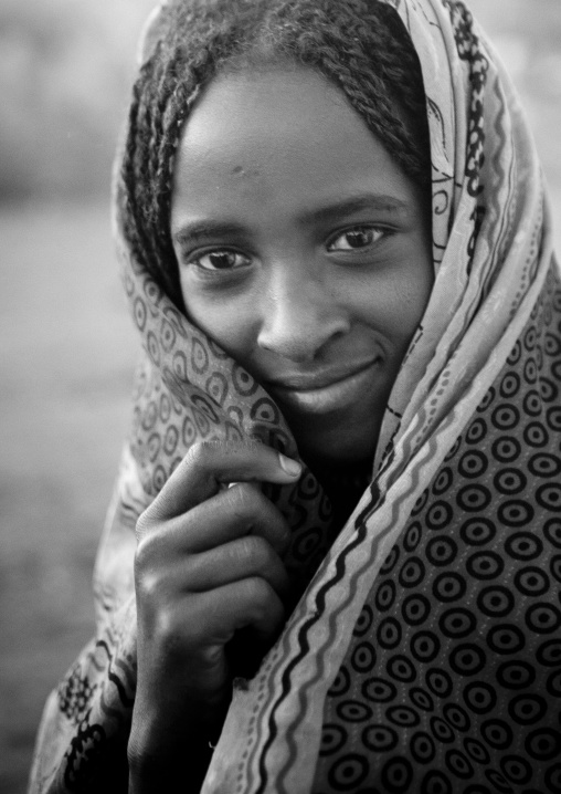 Smiling Karrayyu Tribe Girl With Stranded Hair Hiding Behind Her Headscarf At Gadaaa Ceremony, Metehara, Ethiopia