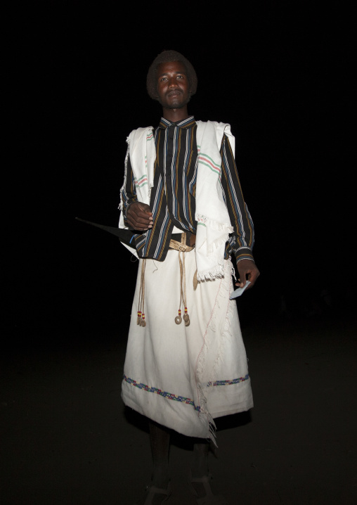 Night Shot Of A Proud Karrayyu Tribe Man In Both Modern And Traditional Clothes During Gadaaa Ceremony, Metahara, Ethiopia