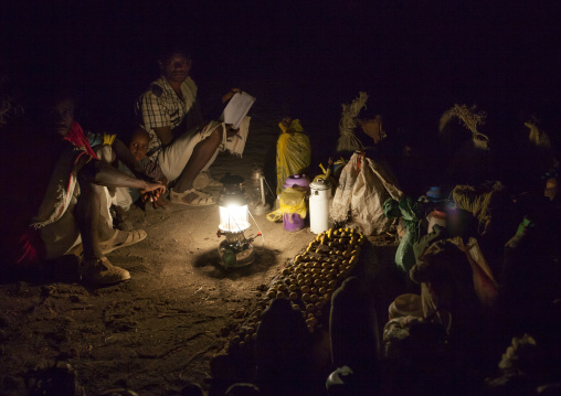 Night Shot Of Karrayyu Tribe Men And Kid Showing The List Of The Gifts Offered To The Families For The Gadaaa Ceremony, Metahara, Ethiopia