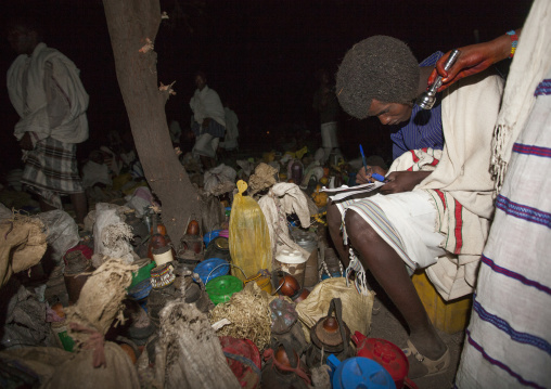 Night Shot Of A Karrayyu Tribe Man Listing The Gifts Offered To The Karrayyu Tribe Families For The Gadaaa Ceremony, Metahara, Ethiopia