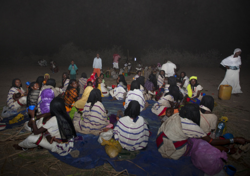 Night Shot Of Karrayyu Tribe Women And Children Drinking And Resting During Gadaaa Ceremony, Metahara, Ethiopia