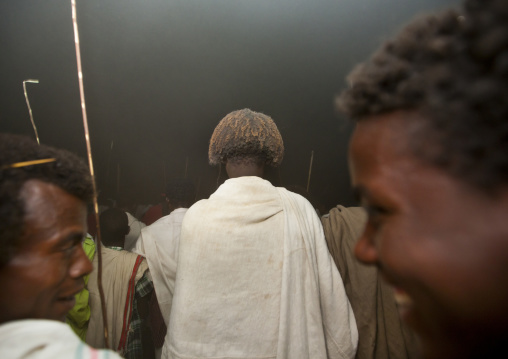 Night Shot Of Two Laughing Karrayyu Tribe Men And Rear View Of Third One Covered With Dust During Gadaaa Ceremony, Metahara, Ethiopia