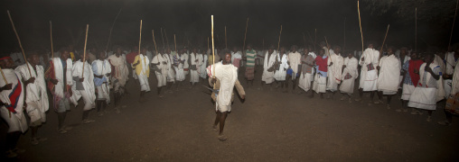 Night Shot Of A Karrayyu Tribe Man Starting A Choreographed Stick Dance In The Middle Of A Circle Made By Karrayyu Men At Gadaaa Ceremony, Metahara, Ethiopia