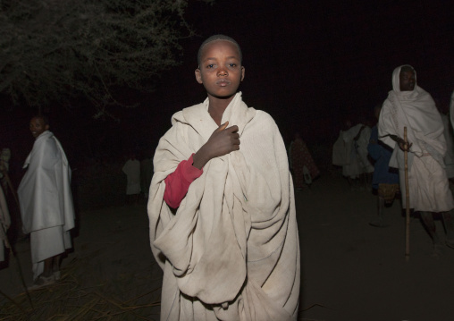 Night Shot Of A Young Karrayyu Tribe Boy Standing Proud Among Other People During Gadaaa Ceremony, Metahara, Ethiopia