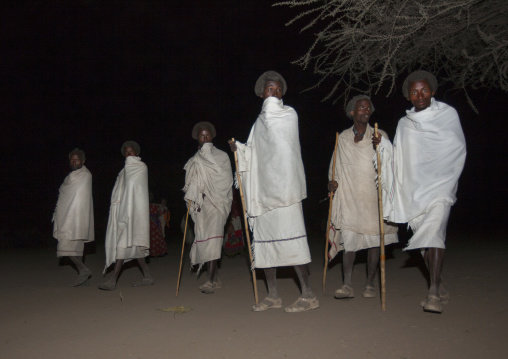 Night Shot Of Six Karrayyu Tribe Teenagers In Wrap Around Clothes And With Traditional Gunfura Hairstyle During Gadaaa Ceremony, Metahara, Ethiopia