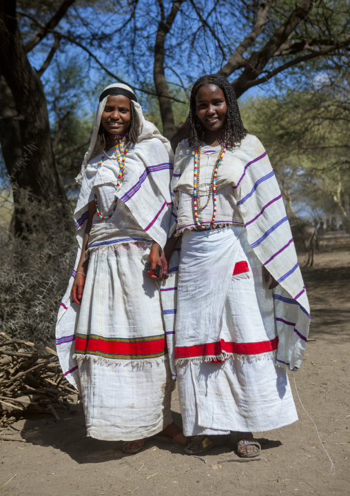 Two Karrayyu Tribe Women In Traditional Clothes With A Mobile Phone And Colourful Necklaces During Gadaaa Ceremony, Metahara, Ethiopia