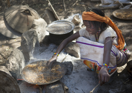 Karrayyu Tribe Woman Squatting To Cook During Gadaaa Ceremony, Metahara, Ethiopia