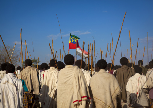Rear View Of A Group Of Karrayyu Tribe Men Carrying The Ethiopian Flag And The Oromo Flags During Gadaaa Ceremony, Metahara, Ethiopia