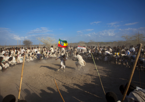 Karrayyu Tribe Man Carrying The Ethiopian Flag During Choreographed Stick Fighting Dance, Gadaaa Ceremony, Metahara, Ethiopia