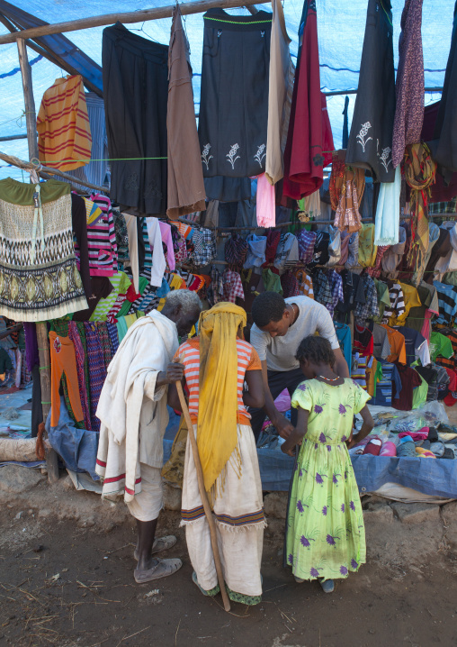 Karrayyu Tribe Family Looking At Goods On Display In Clothes Shop In Metahara Market, Ethiopia