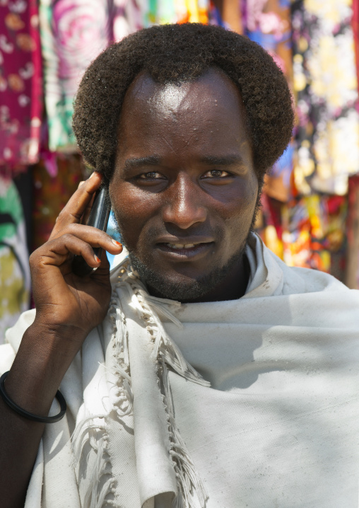 Portrait Of A Karrayyu Man With Traditional Gunfura Hairstyle, Talking On The Phone, Metehara, Ethiopia