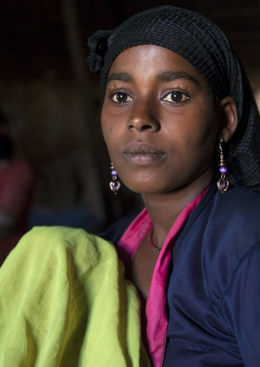 Portrait of a young Ethiopian mother breastfeeding her baby, Alaba, Ethiopia