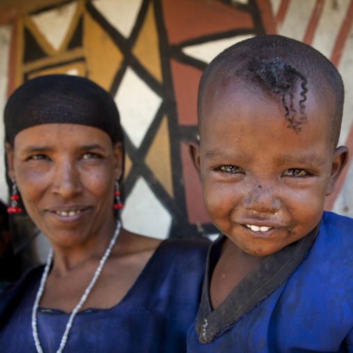 Portrait of a kid and mother with toothy smiles, Alaba, Ethiopia