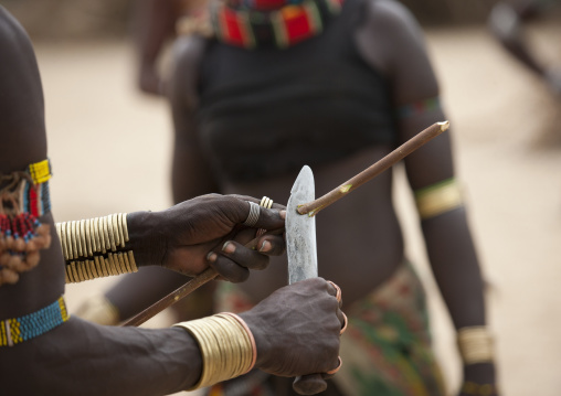 Whipper Cutting His Wooden Whip Before Celebrating Bull Jumping Ceremony, Omo Valley, Ethiopia