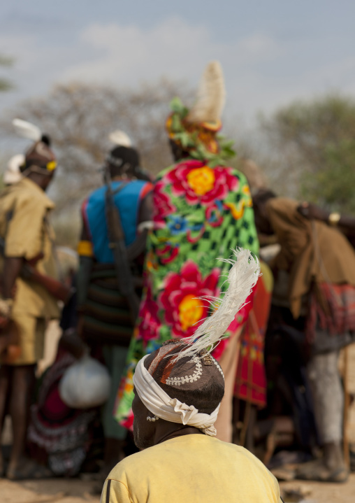 Hamer Men Standing During Bull Leaping Ceremony And One Sitting With A Feather Ornament On His Head, Omo Valley, Ethiopia
