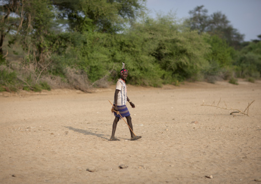 Hamer Tribe Man Walking Through A Desert Area, Omo Valley Ethiopia