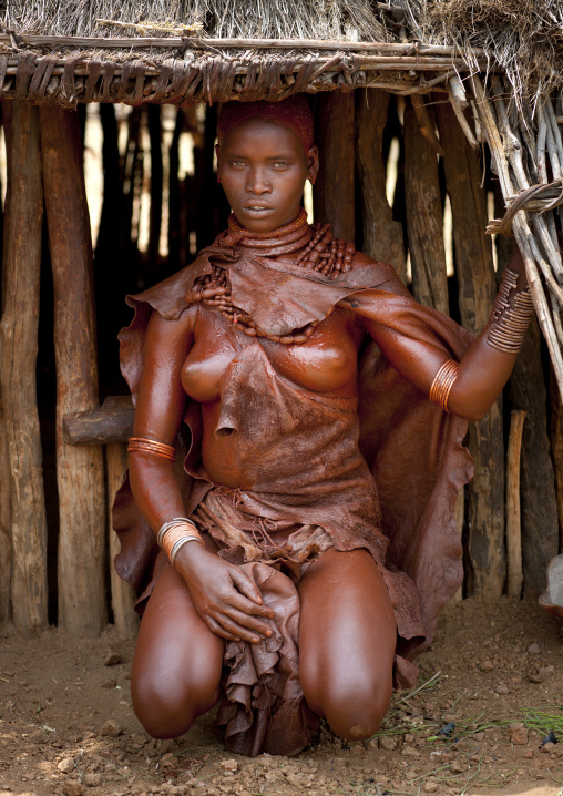 Utah Woman From The Hamer Tribe Squatting In Her Hut, Omo Valley, Ethiopia