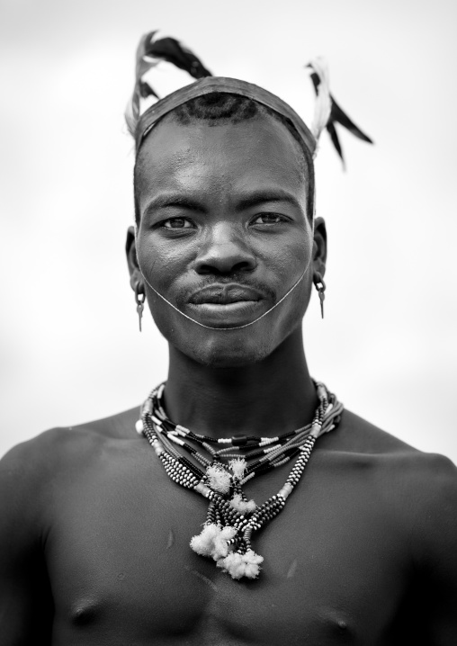 Portrait Of Bare Chest And Feather Headgear Banna Whipper Man Omo Valley Ethiopia