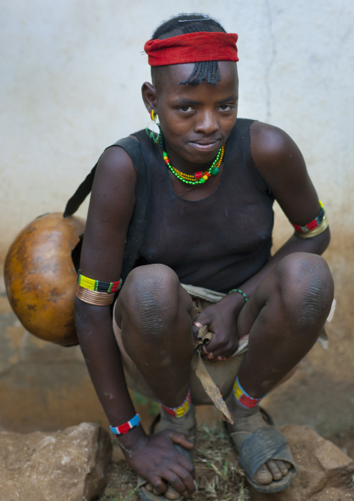 Shy squatting ari teenage girl omo valley Ethiopia