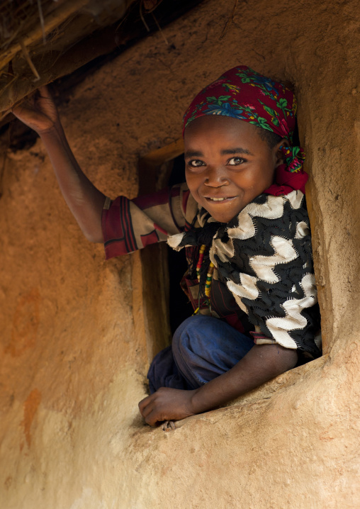Young ari girl in a window frame jinka omo valley Ethiopia