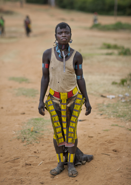 Tsemay tribe woman wearing a traditional suit at key afer market, Omo valley, Ethiopia