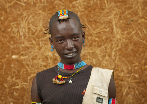 Fashionable tsemay tribe teenager boy posing in key afer, Omo valley, Ethiopia