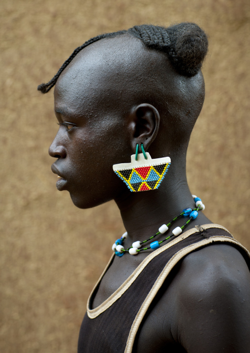 Profile of a fashionable tsemay tribe man posing in key afer, Omo valley, Ethiopia