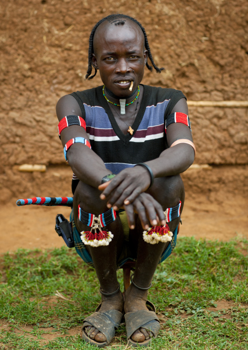 Fashionable tsemay tribe man with a traditional hairstyle posing in key afer, Omo valley, Ethiopia