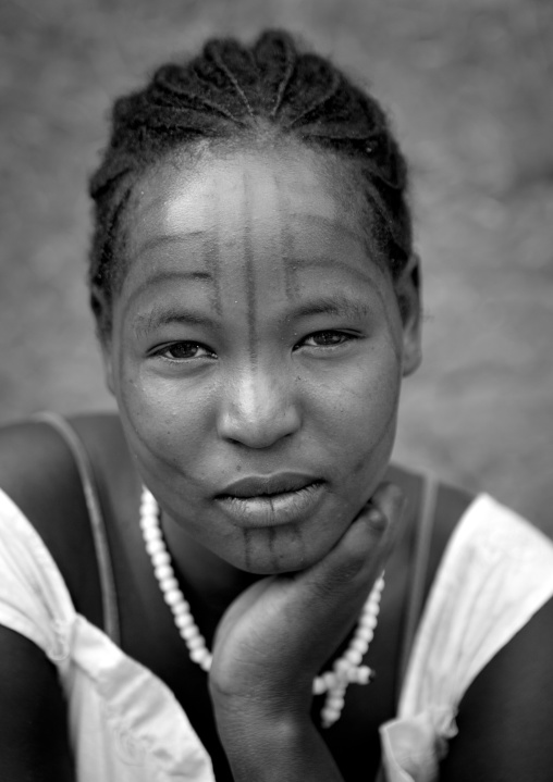 Tattooed face of a tsemay tribe woman at key afer market, Omo valley, Ethiopia