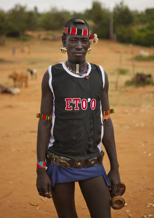 Fashionable tsemay tribe man posing in key afer, Omo valley, Ethiopia
