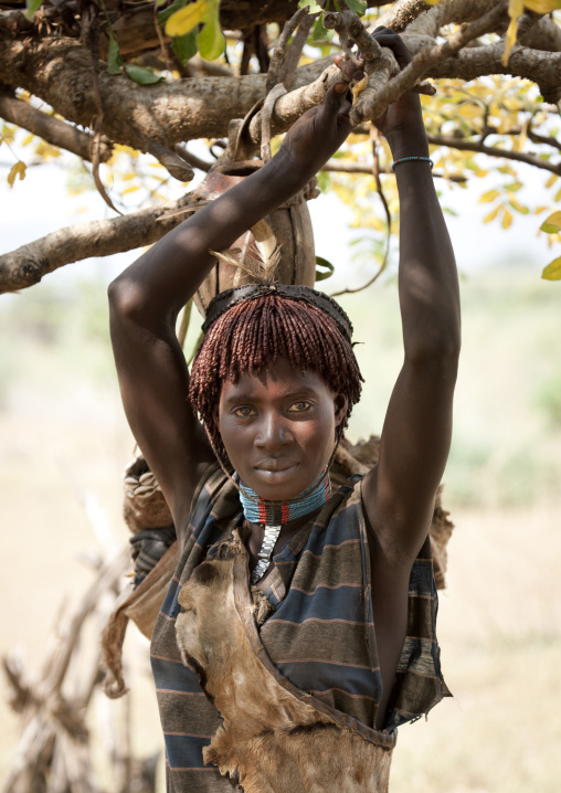 Young Bana Woman Hanging From Branch Ethiopia
