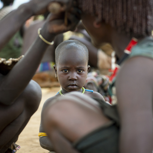 Baby Watching Ochred Braids Haircut Of Banna Woman Ethiopia