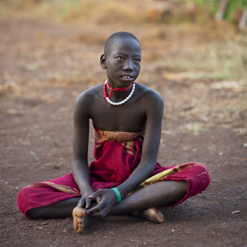 Teenage Bodi Boy Wearing Loincloth Sitting On The Floor Omo Valley Ethiopia