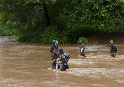 Bodi Women Crossing Brownish Water Of The River  Omo Valley Ethiopia