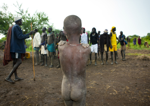 Little Naked Bodi Boy Covered With Clay Looking At Men Celebrating Kael New Year Ceremony Omo Valley Ethiopia
